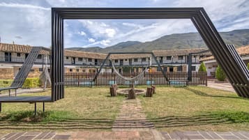 Relax by the central fire pit in this serene courtyard, surrounded by a mountain range.