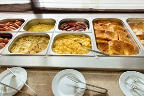 A buffet with various food options including eggs, sausages, and scrambled eggs. - Target Hospitality-Stanley Hotel (Stanley)