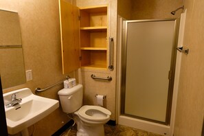 A bathroom with a sink, toilet, and a walk-in shower. - Target Hospitality - Orla South Lodge (Orla)
