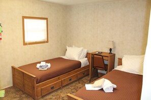 A bedroom with two beds, a desk, and a chair. - Target Hospitality-Orla North Lodge (Orla)