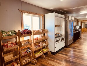 A bakery display with various baked goods and snacks.