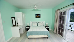A bedroom with a bed, nightstands, a dresser, a ceiling fan, a window with curtains, and a view of the outdoors. - *Sugarmon Villas* Mout Gimmie Suite with amazingPergola Balcony View! (Soufriere)
