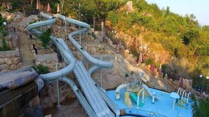 A water park with multiple slides and a swimming pool. - SoHo Apartment (Bac Nha Trang)