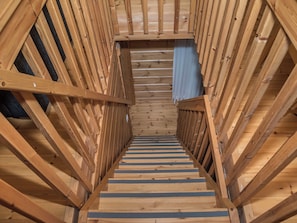 A wooden staircase with a handrail, leading to a higher level. - Koskelo by Interhome (Äkäslompolo)