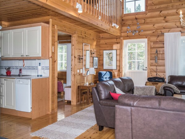 A wooden cabin interior with a kitchen, dining area, and living room. - Koskelo by Interhome (Äkäslompolo)