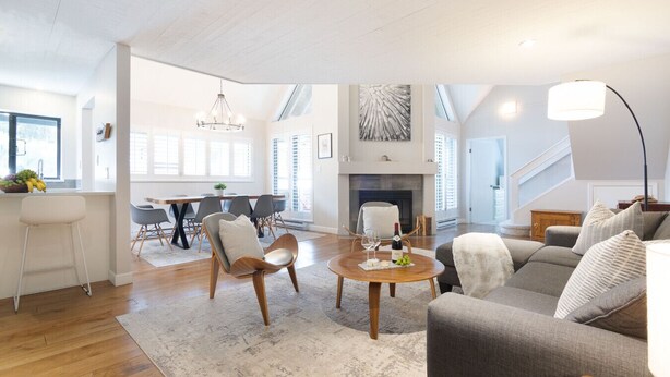 A spacious living area with a dining table, chairs, a fireplace, and a sofa. - Luxury 3BR/2BA-1700 sq ft, Mountain view,BBQ (Whistler)