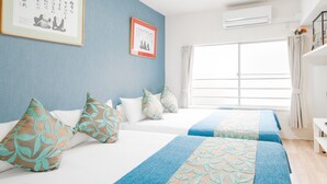A hotel room with two beds, a large window, and a ceiling fan. - Sakuragawa no Shima (Osaka)