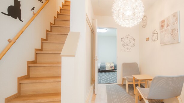 A staircase leading to a bedroom with a bed, a desk, and a chair. - Sakuragawa no Shima (Osaka)