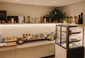 A buffet setup with various food items and a glass display case.