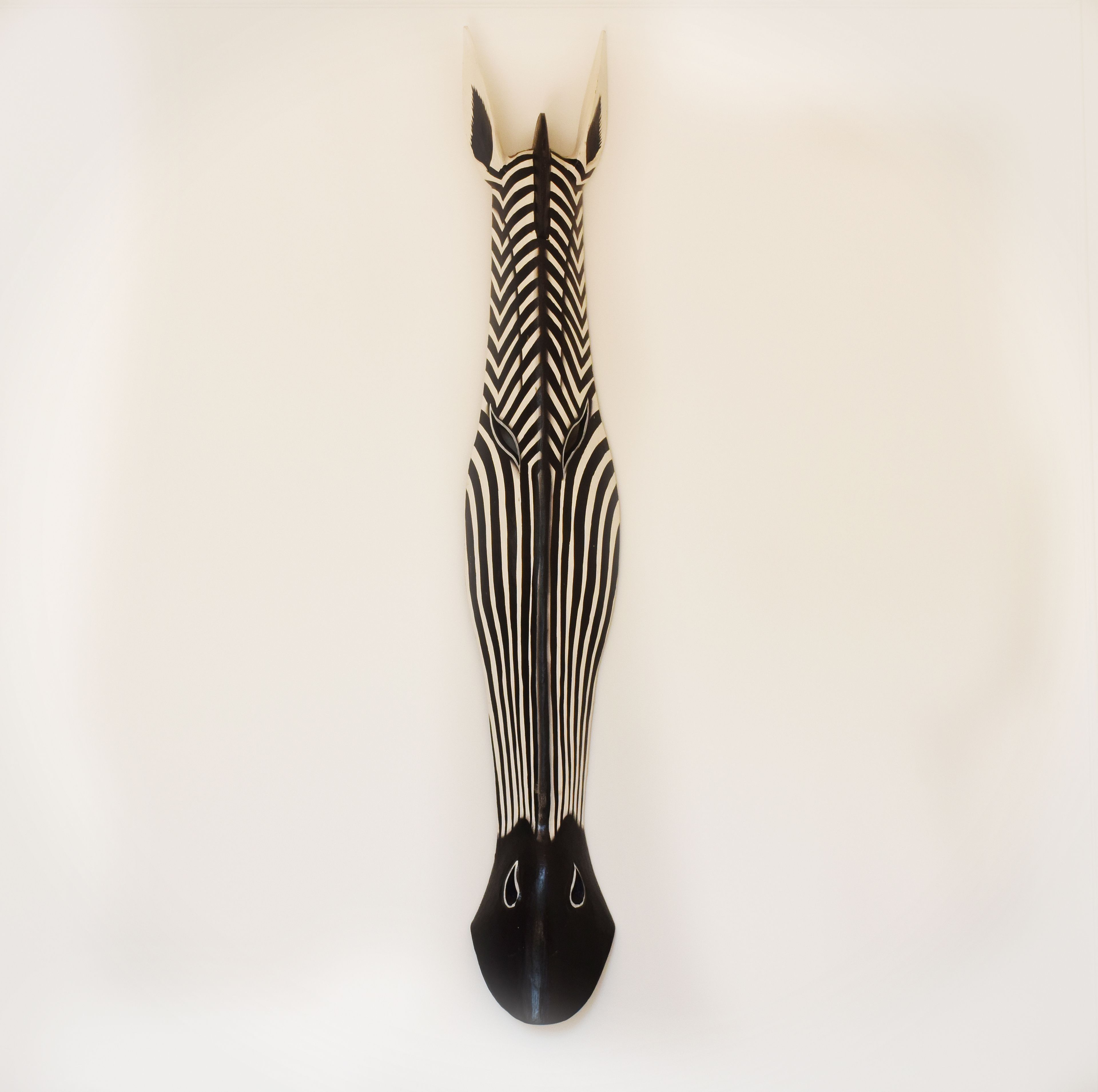 A zebra head mounted on a wall.