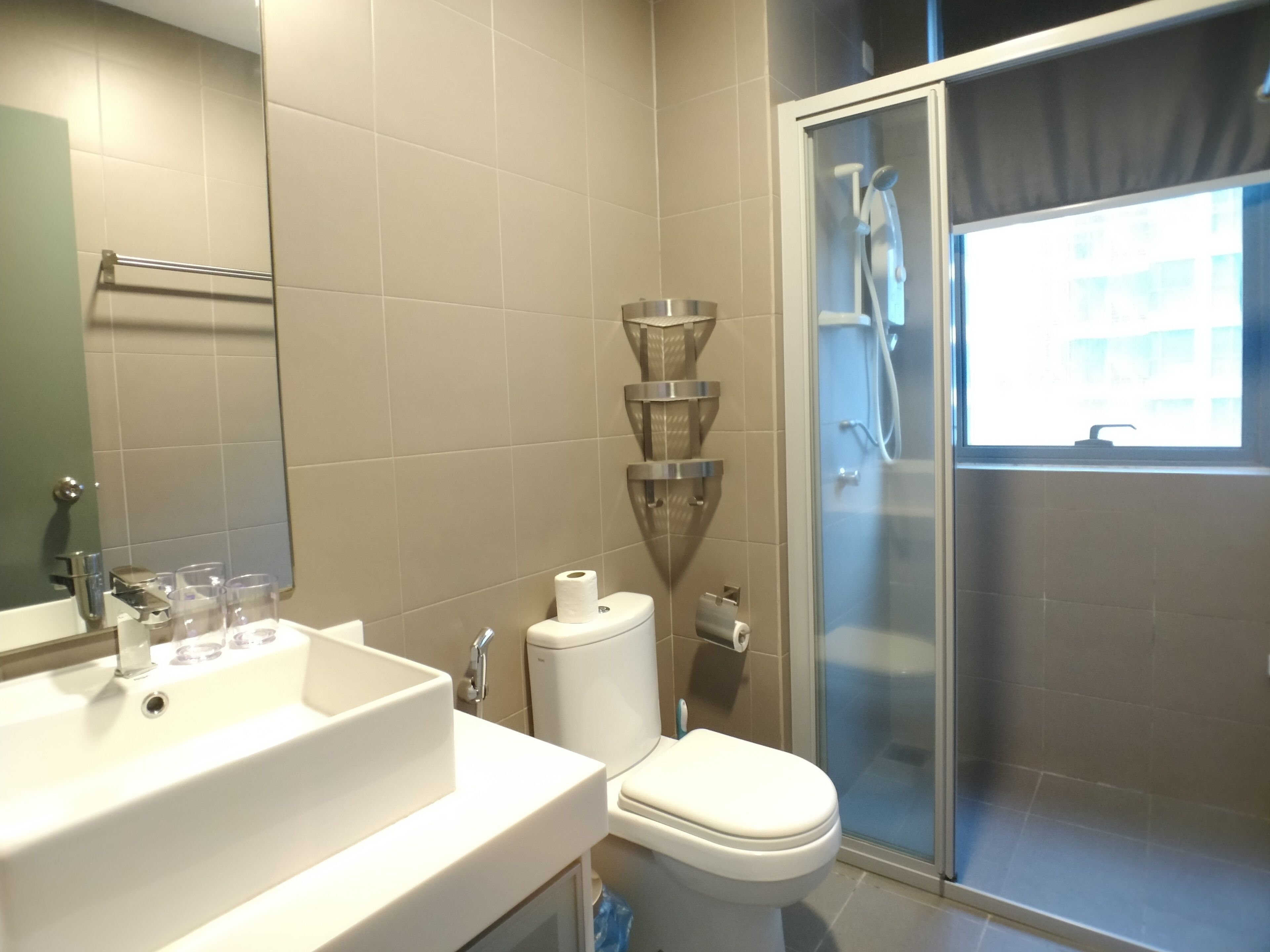 A bathroom with a sink, toilet, and shower.