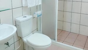 A bathroom with a toilet, sink, and glass shower enclosure. - Happy Owner Homestay (Ruisui)