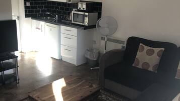 Deluxe Apartment | Living area | Flat-screen TV