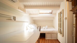 A compact bedroom with a bunk bed, a small desk, and a window with a view. - Solemar Sicilia - Casa Olivia (Santa Flavia)
