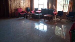A spacious living room with a wooden ceiling, a sofa set, a coffee table, and two armchairs. - Mara Silalei (Narok)