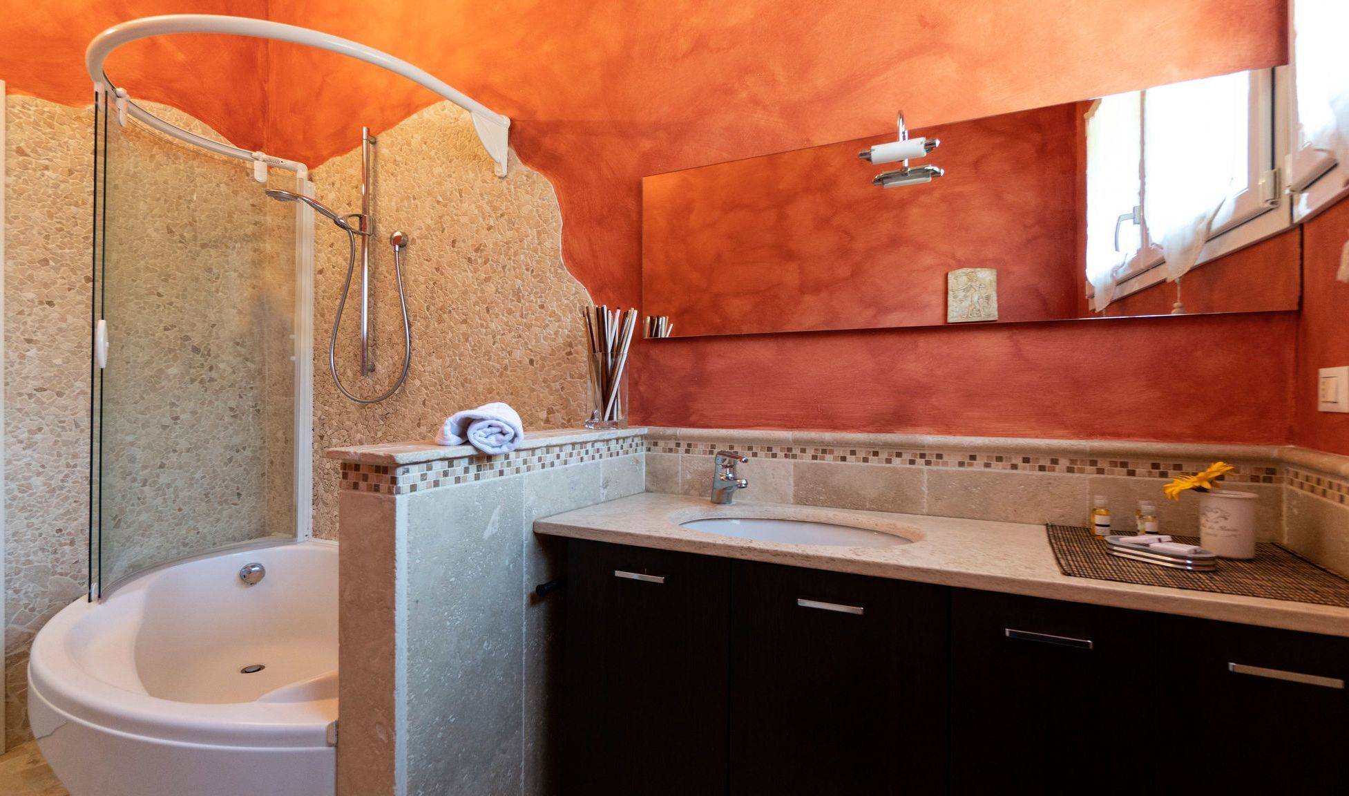 A bathroom with a bathtub, a sink, and a shower.