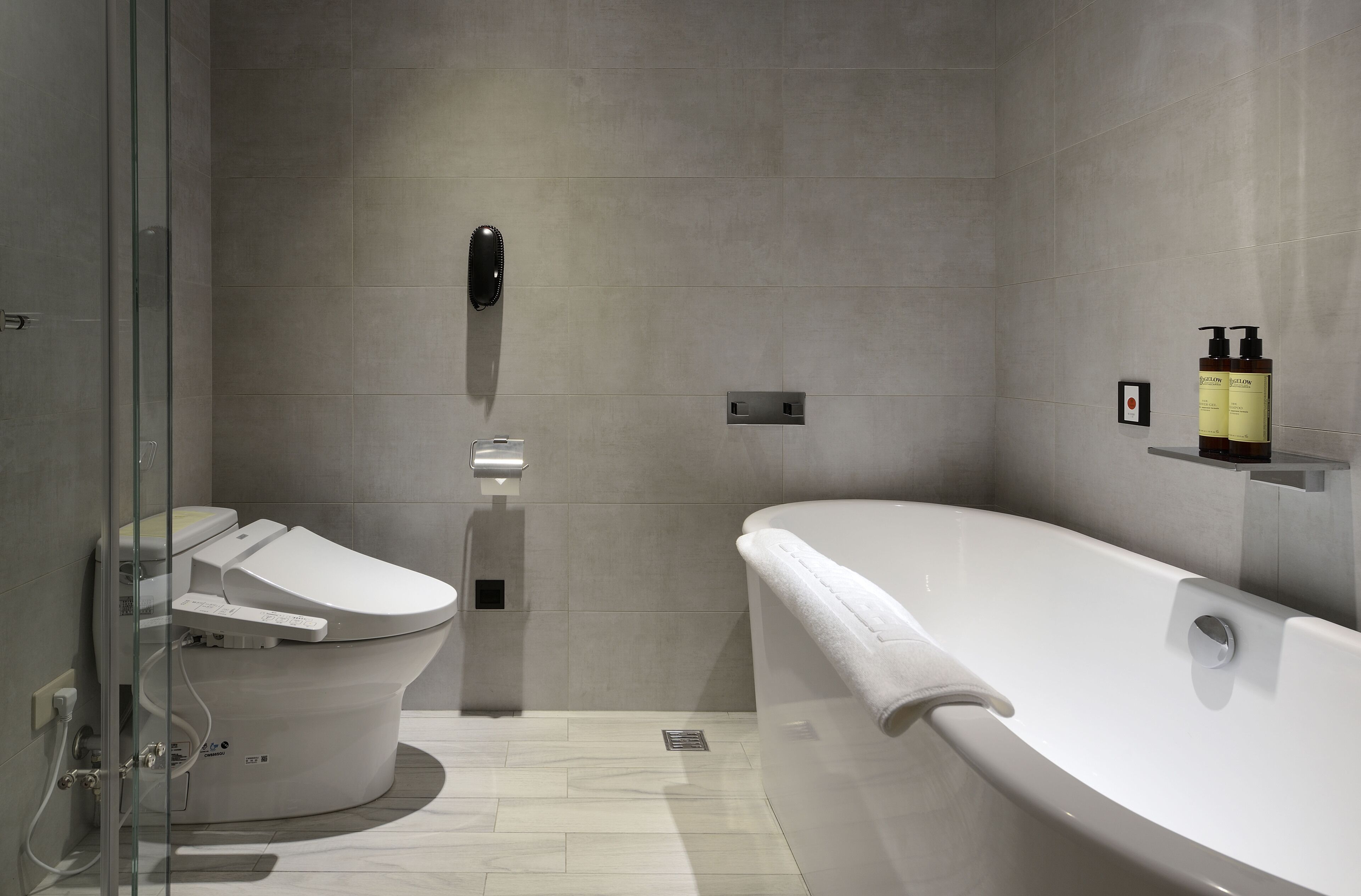 Ein modernes Badezimmer mit Toilette, Bidet und Badewanne.