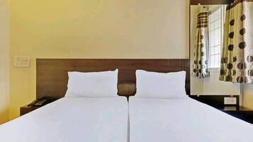 Deluxe Non Ac Room | Premium bedding, soundproofing, rollaway beds, bed sheets