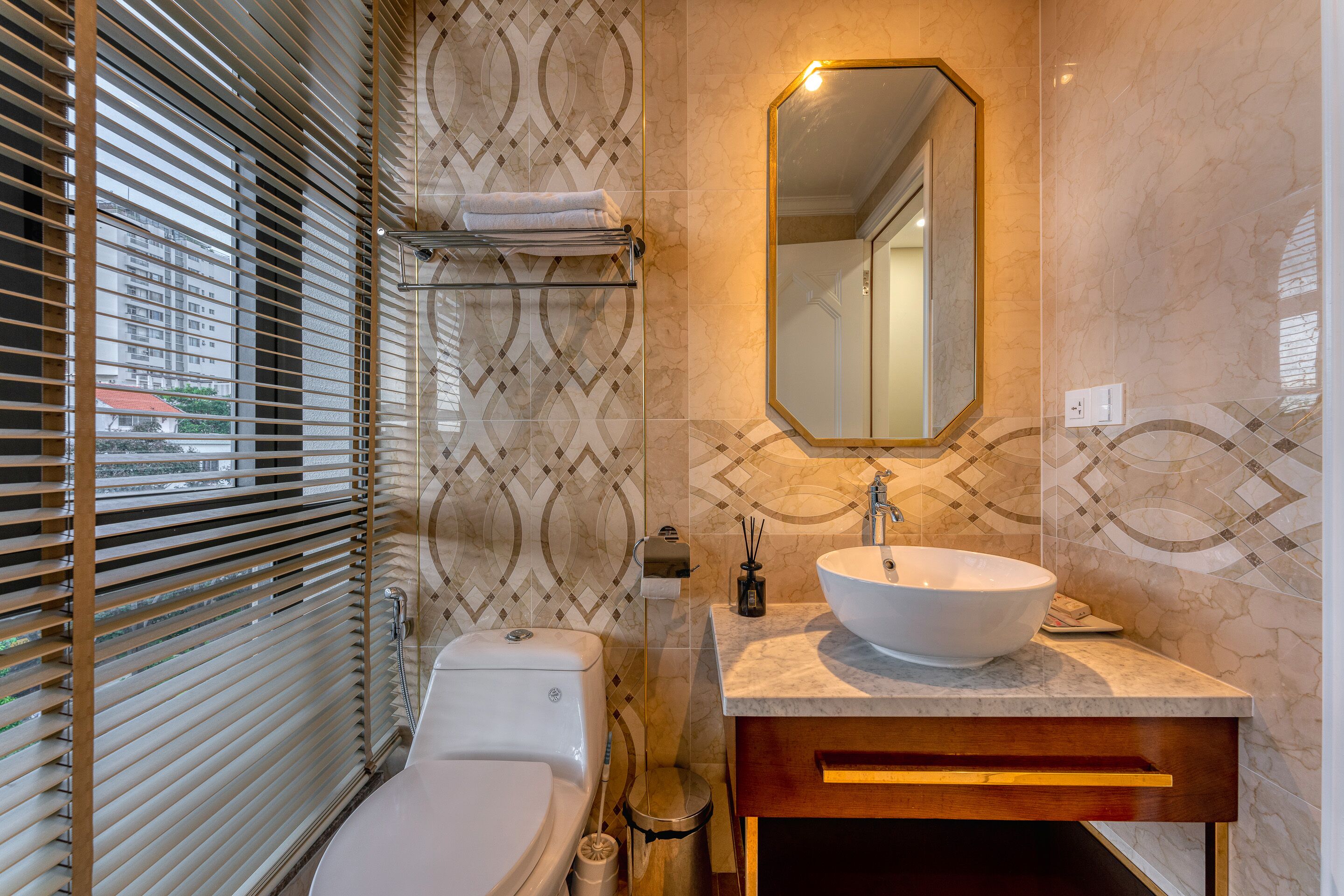 A bathroom with a toilet, sink, and mirror.