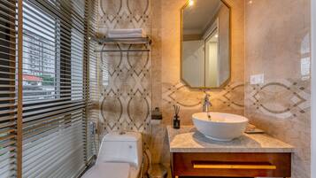 A bathroom with a toilet, sink, and mirror.