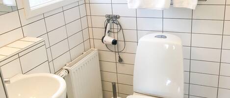 A bathroom with a toilet, bidet, and sink.