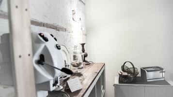 A kitchen with a coffee machine, a basket of bread, and a toaster.
