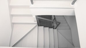 A modern staircase with a glass ceiling, metal railings, and a minimalist design. - Bookbreakfast (Terme Vigliatore)