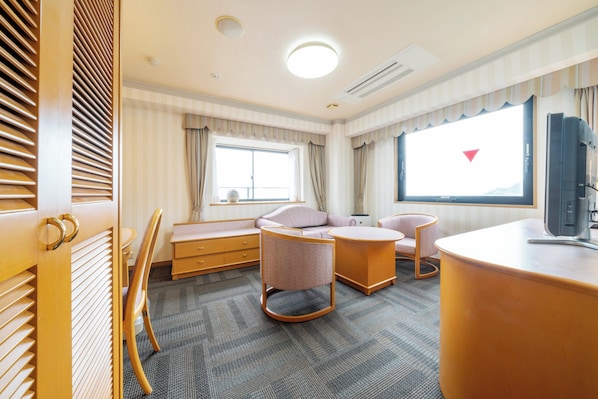 A hotel room with a large window, a television, a desk, and two chairs. - Hotel Castle inn Isemeotoiwa (Ise)