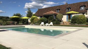 Relax by the serene pool surrounded by lush landscaping and comfortable lounge chairs.