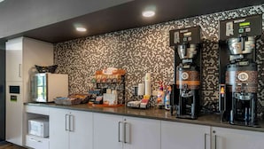 A modern kitchen with a coffee station, microwave, and storage cabinets. - Extended Stay America Premier Suites Port Charlotte I75 (Port Charlotte)