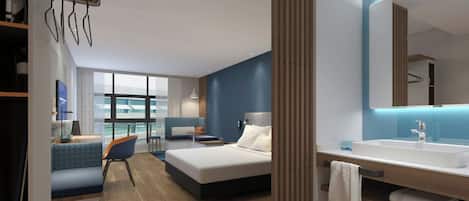 A modern hotel room with a bed, a desk, a chair, a large window, and a bathroom with a sink and mirror.