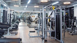 A gym with various exercise equipment, mirrors, and a clean, organized layout. - Holiday Inn Express Hangzhou Jiuzhou by IHG (Hangzhou)
