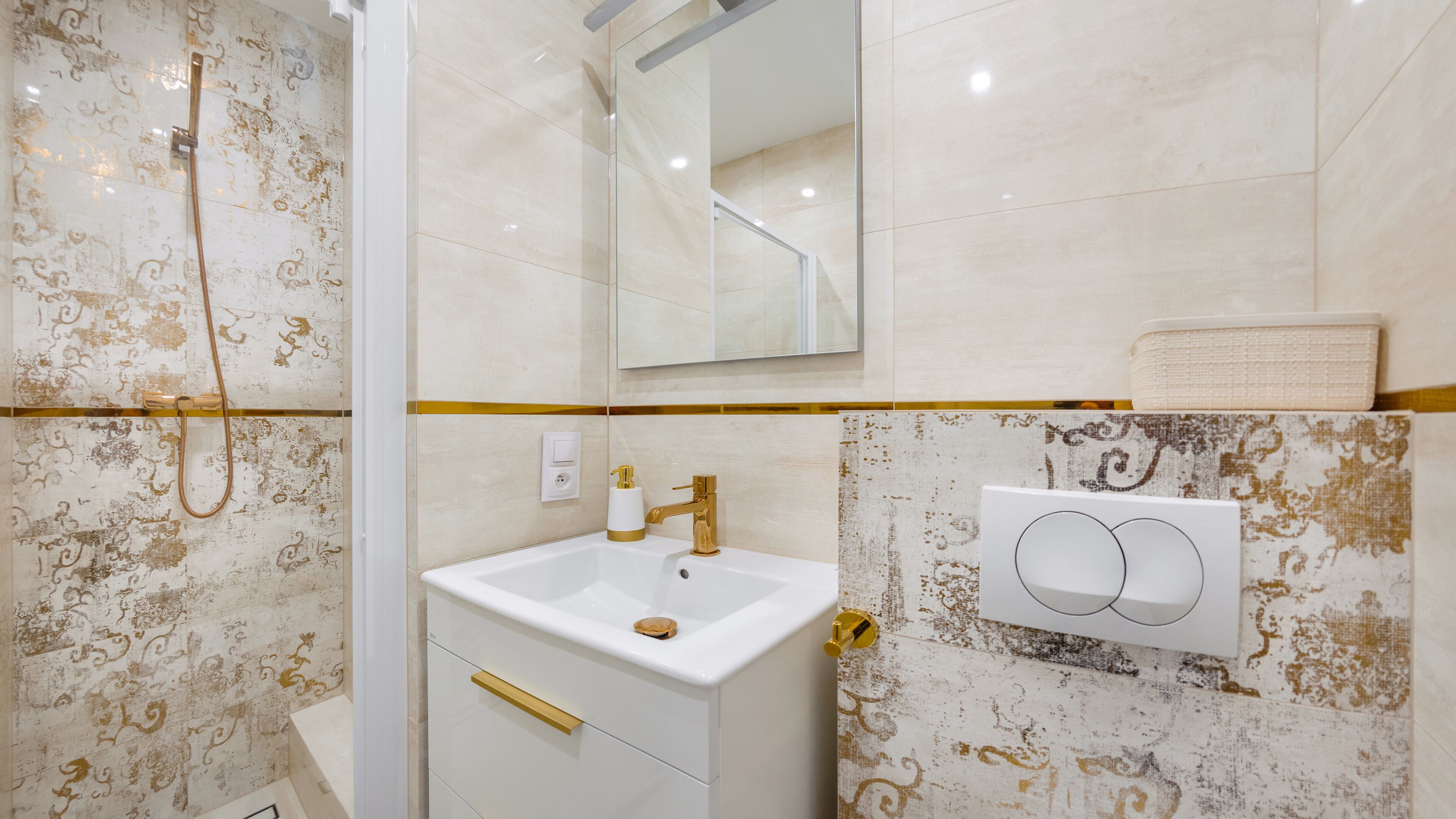 A bathroom with a shower, a sink, a mirror, and a towel rack.