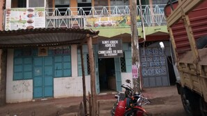 A multi-story building with a sign for 'Kings Guest Rooms' indicating deluxe accommodations. - Kings Guest House (Kabati)
