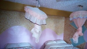 A room with two beds, each with a white bedspread and a decorative canopy. - Haricot Guest House (Murang'a)