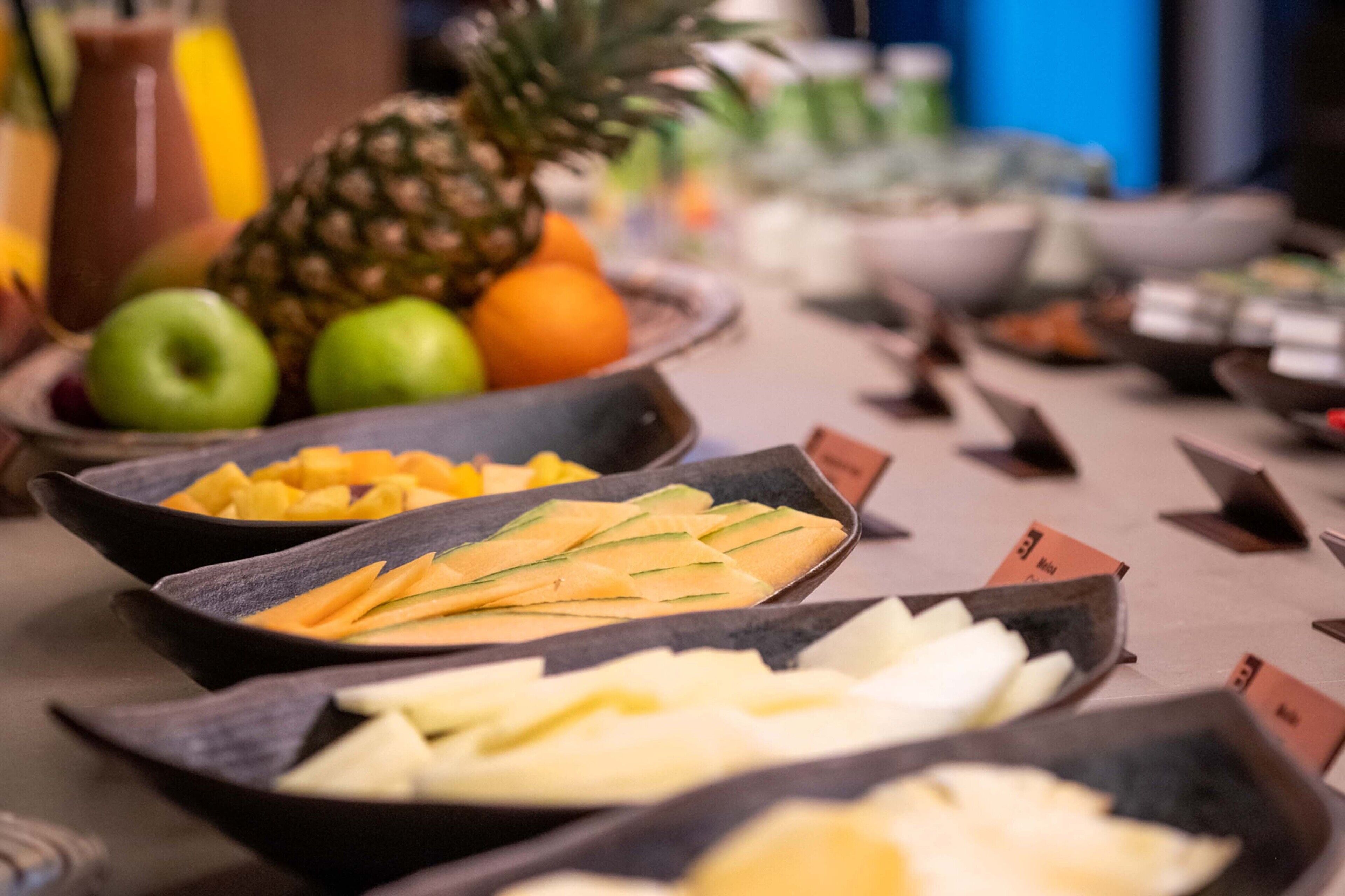 A buffet with various fruits and vegetables.