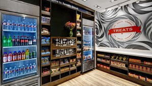 A farmers branch with a variety of snacks, drinks, and treats. - Hampton Inn & Suites Farmers Branch Dallas (Farmers Branch)