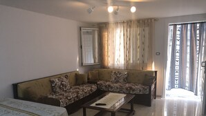 A living room with a sofa set, a coffee table, and a dining table. - Tazarka House (Korba)