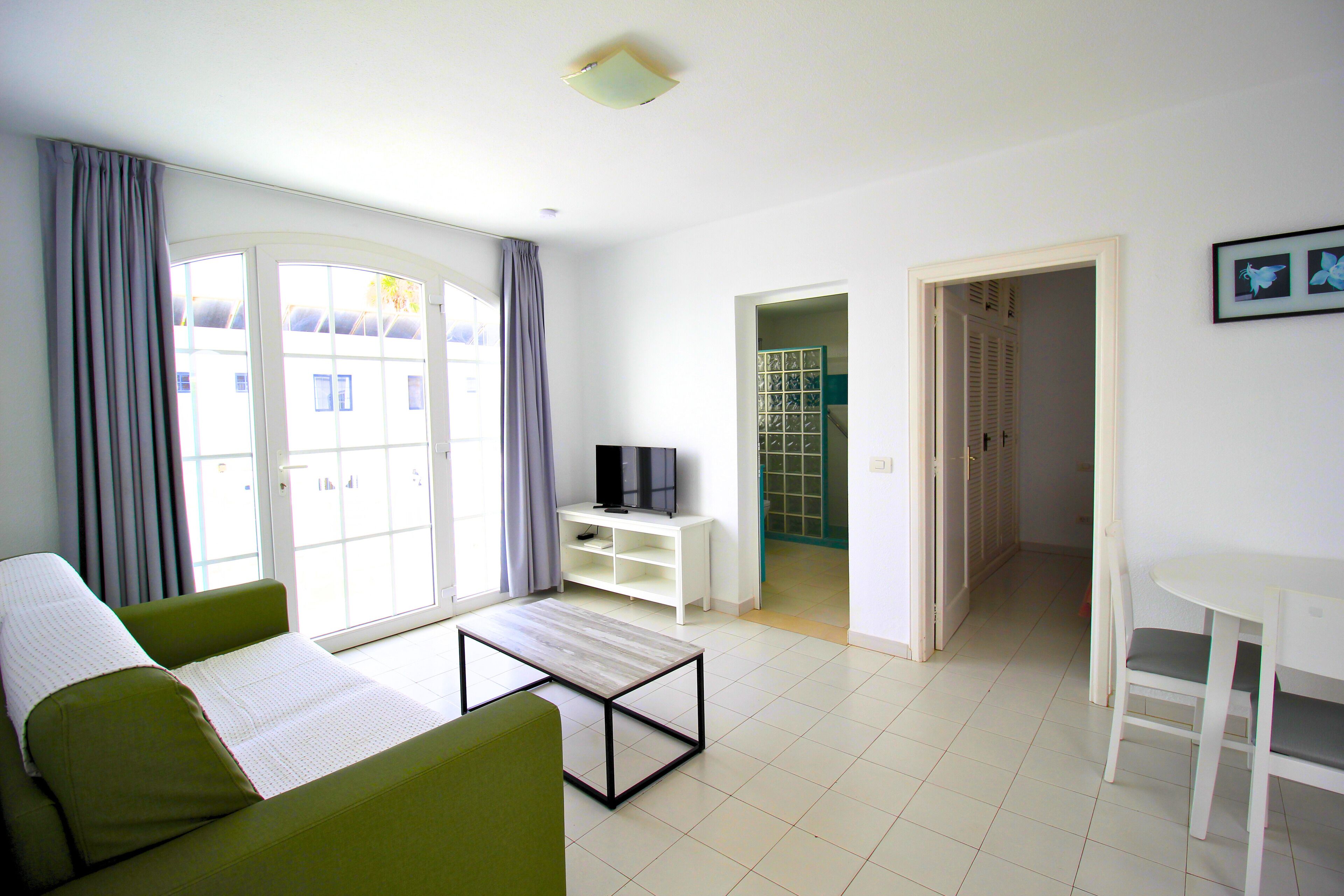 Economy Apartment, 1 Bedroom | Living room | 30-inch flat-screen TV with cable channels, TV