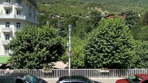 A building with balconies, surrounded by trees and a mountainous backdrop. - Central studio with parking, 2 people. (Brides-les-Bains)