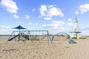 Enjoy a seaside escape with swings and a slide at this beachside playground.