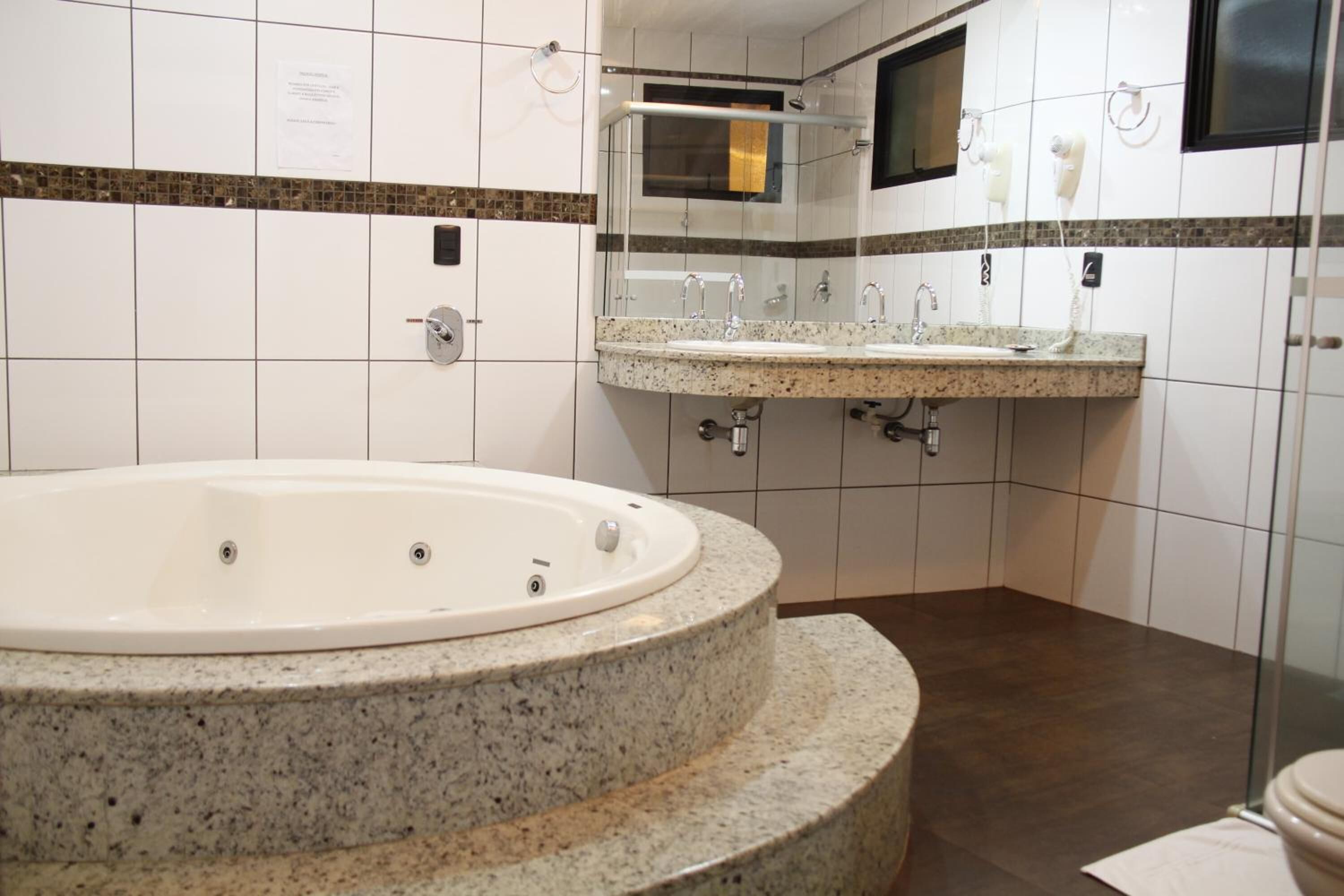 Shower, designer toiletries, hair dryer, towels