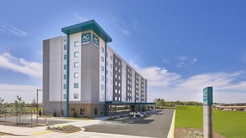 AC Hotels offers a sleek, modern building with a flat roof and grid-patterned windows.