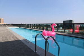 Seasonal outdoor pool, open 3:30 PM to 10:00 PM, pool umbrellas