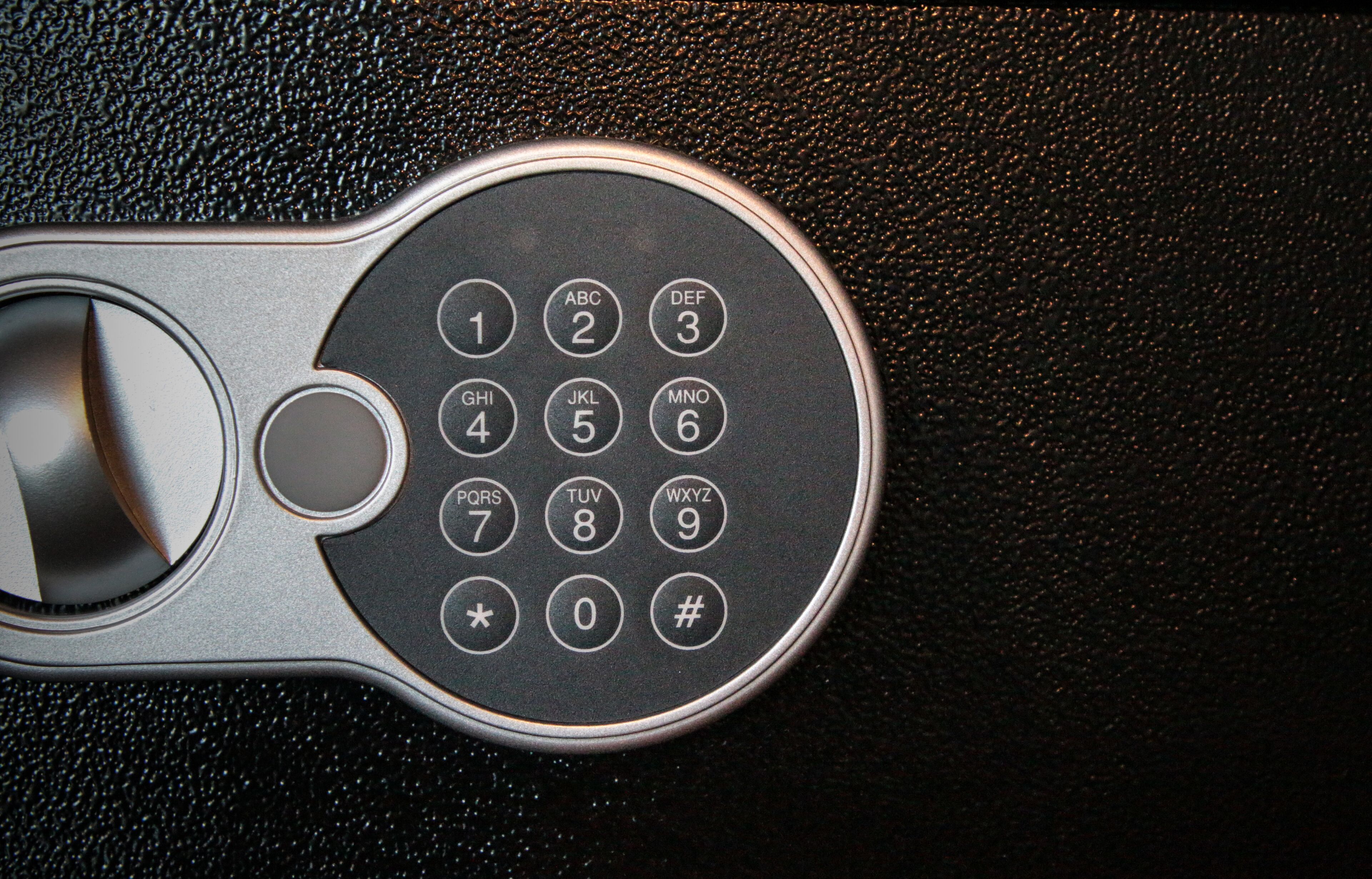 A car key fob with a numeric keypad and a button.