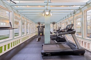 A covered gym area with exercise equipment, large windows, and a view of the outside. - Hilton Head Resort Condo with Private Beach Boardwalk & Indoor Pool! (Hilton Head Island)