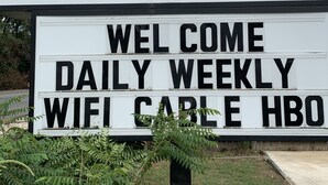 A sign for The Village Inn Motel with amenities including daily, weekly, wifi, cable, and HBO. - The Village Inn (Denham Springs)