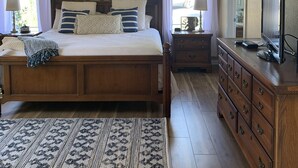 A bedroom with a bed, nightstands, a dresser, a ceiling fan, and a window with curtains. - THE AMERICAN DREAM “Where to Stay When Away” (Ardmore)