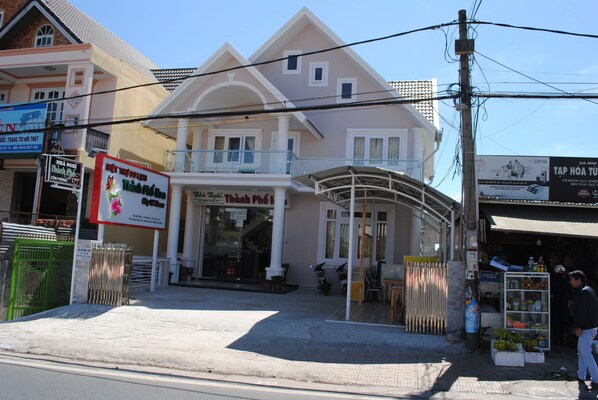 A two-story building with a balcony and a storefront.