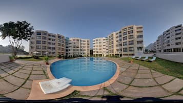 2 outdoor pools, open 7:00 AM to 7:00 PM, pool umbrellas